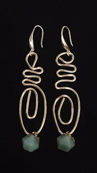 a pair of gold - plated earrings with a green stone