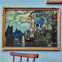 a painting on a wall next to a chair